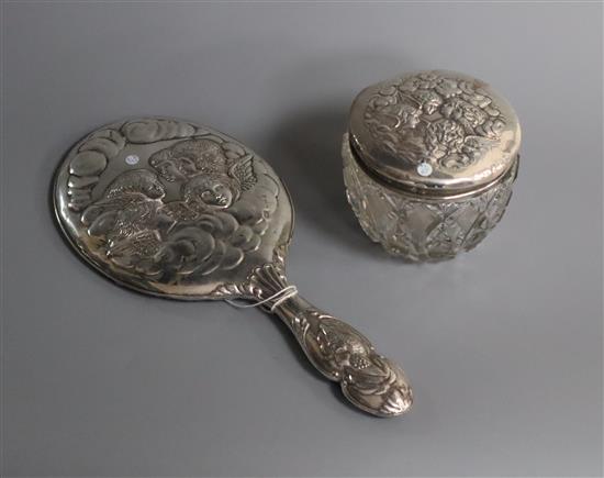 An Edwardian silver Reynolds Angels decorated toilet jar and hand mirror.